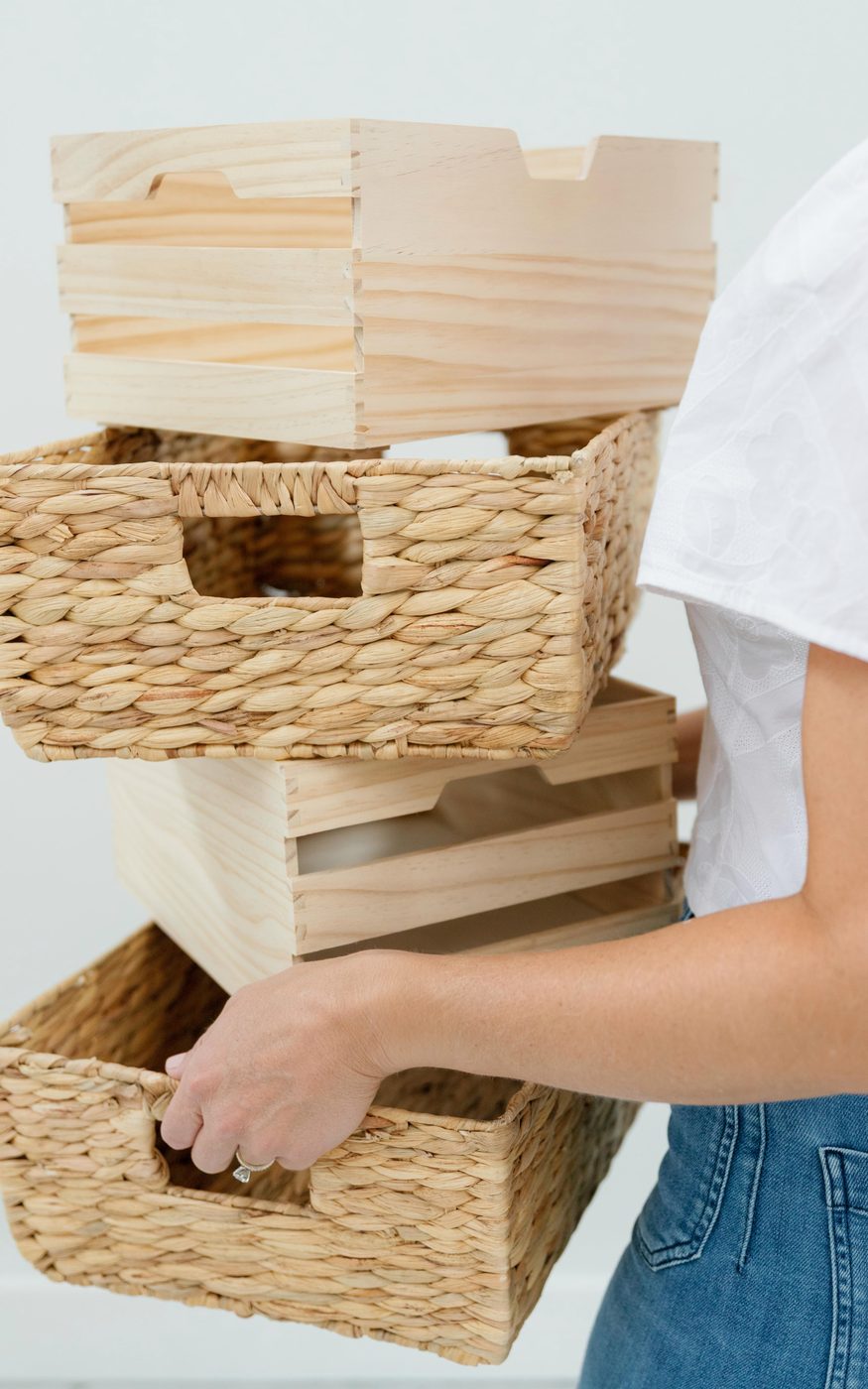 Stacked woven and wooden storage baskets